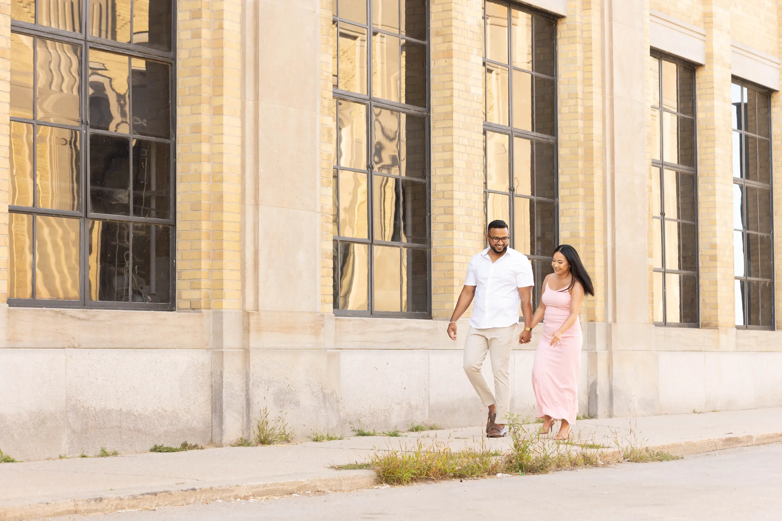 An image of the soon to be married couple Trevin and Carisa walking and laughing.